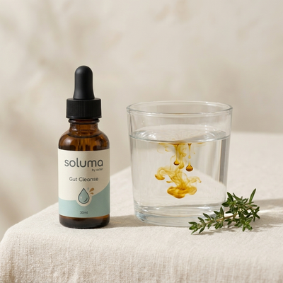 SOLUMA drops in a glass of water